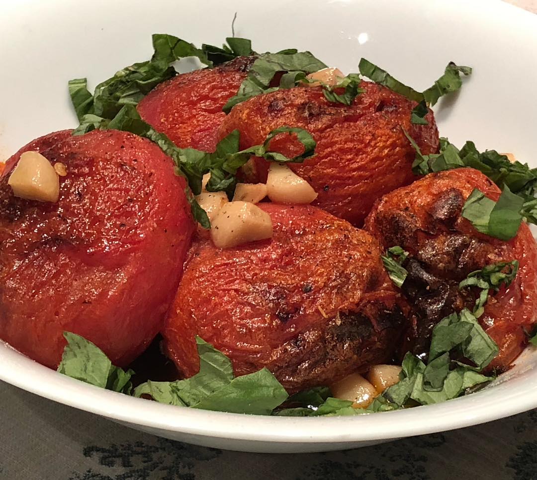 Whole plum tomatoes (peeled) and roasted (30-35 min) in a preheated 425f oven (convection roast mode)till tender but not-yet collapsed (still toothsome) with garlic confit and dried oregano -salt and pepper. Served with fresh basil. Amazing with burrata